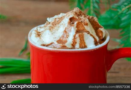 Cap of coffee with whipped cream. Cup with coffee. Whipped cream hot coffee in a red mug