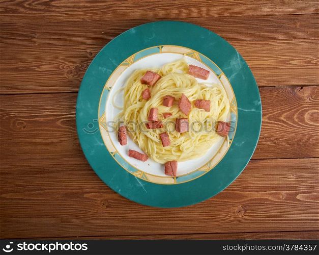 Capellini pasta with cream sauce Alfredo and sausage.