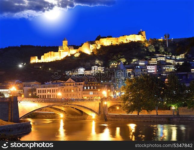 Capital of Georgia - Tbilisi at night against the dark blue sky