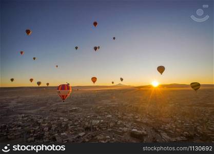 CAPPADOCIA, TURKY - 19 December 2019 : Aerial beautiful landscape view of balloons flight in the morning with sunrise sky background
