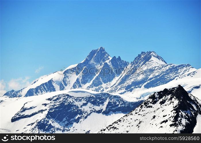 capped mountain peaks and blue sky