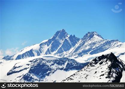 capped mountain peaks and blue sky