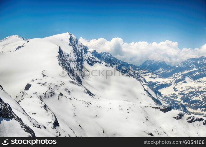 capped mountain peaks and blue sky