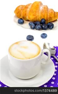 Cappuccino, blueberry and fresh croissant for breakfast. Studio Photo. Cappuccino, blueberry and fresh croissant for breakfast