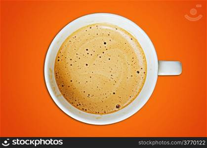 Cappuccino coffee cup and beans on a orange background