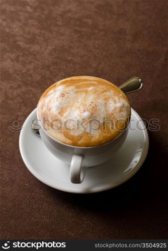 Cappuccino coffee cup closeup at the table