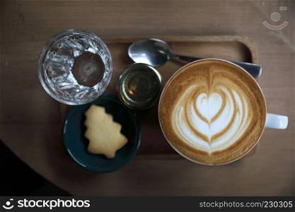 Cappuccino coffee cup on wood background top view