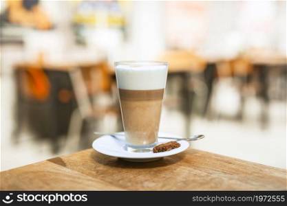 cappuccino coffee glass with spoon wooden table. High resolution photo. cappuccino coffee glass with spoon wooden table. High quality photo
