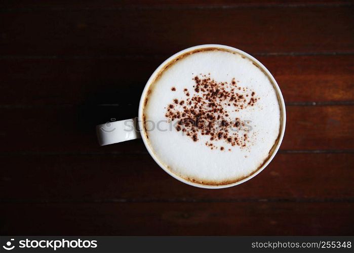 cappuccino coffee on wood background in coffee shop