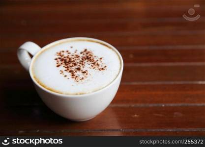 cappuccino coffee on wood background in coffee shop