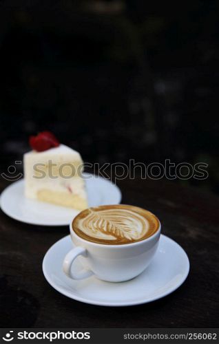 cappuccino coffee with cake on wood background