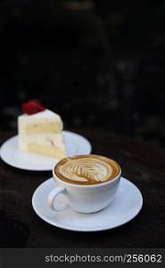 cappuccino coffee with cake on wood background