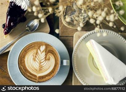 Cappuccino coffee with latte art and cake slice desserts