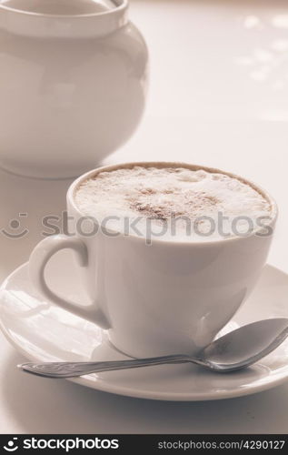 Cappuccino cup on a light background. Shallow depth of field
