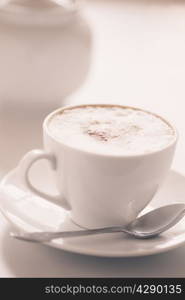 Cappuccino cup on a light background. Shallow depth of field