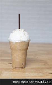 cappuccino frappe with whipping cream on wooden table