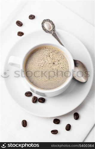 Cappuccino in the white cup on a napkin
