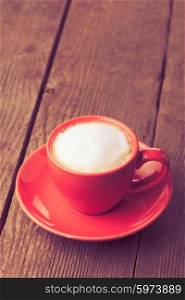Cappuccino or coffee in red cup - vintage style. coffe in red cup