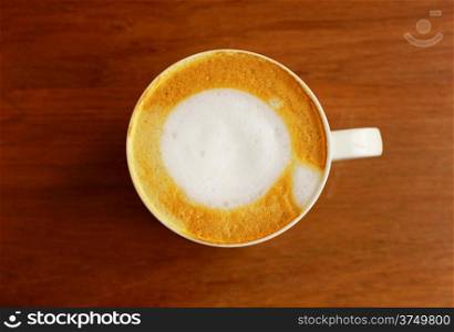 Cappuccino or latte coffee on wooden table