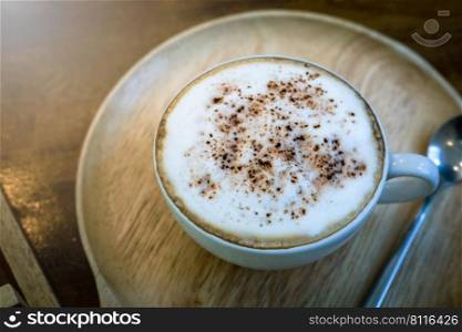 Cappuccino or latte coffee with frothy foam, coffee cup top on wooden classic vintage style coffee time