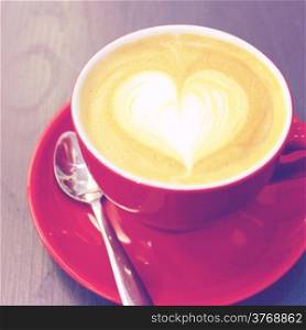 Cappuccino or latte coffee with heart shape, retro filter effect