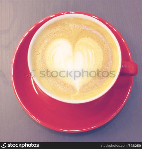 Cappuccino or latte coffee with heart shape, retro filter effect