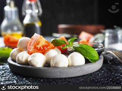 Caprese salad. Healthy meal with cherry tomatoes, mozzarella balls, spices, fresh rocket and basil. Home made, tasty food. Symbolic image.. Caprese salad. Healthy meal with cherry tomatoes, mozzarella balls, spices, fresh rocket and basil.