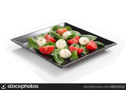 caprese salad in plate isolated on white background