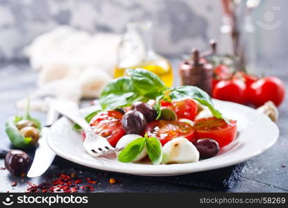 caprese salad on plate and on a table