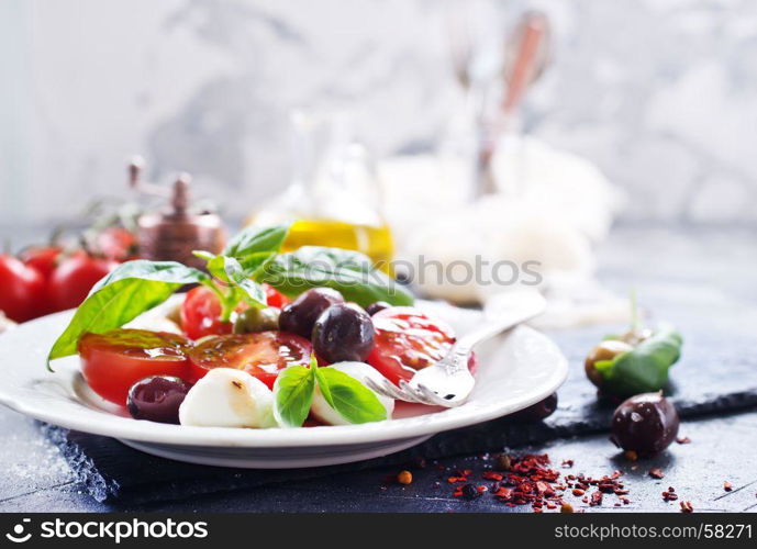 caprese salad on plate and on a table