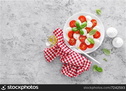 Caprese salad. Salad with mozzarella cheese fresh tomatoes, basil leaves and olive oil. Italian food