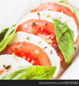 Caprese salad: slices of tomato and mozzarella cheese