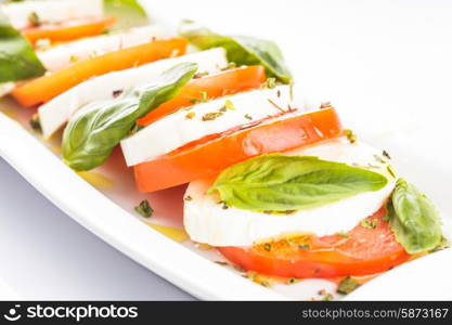 Caprese salad: slices of tomato and mozzarella cheese. Caprese salad