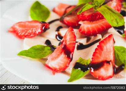 Caprese salad with strawberry, mozzarella, basil and balsamic