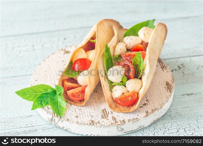Caprese tacos on the wooden board