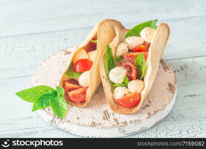 Caprese tacos on the wooden board