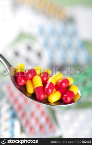 capsule pills in spoon