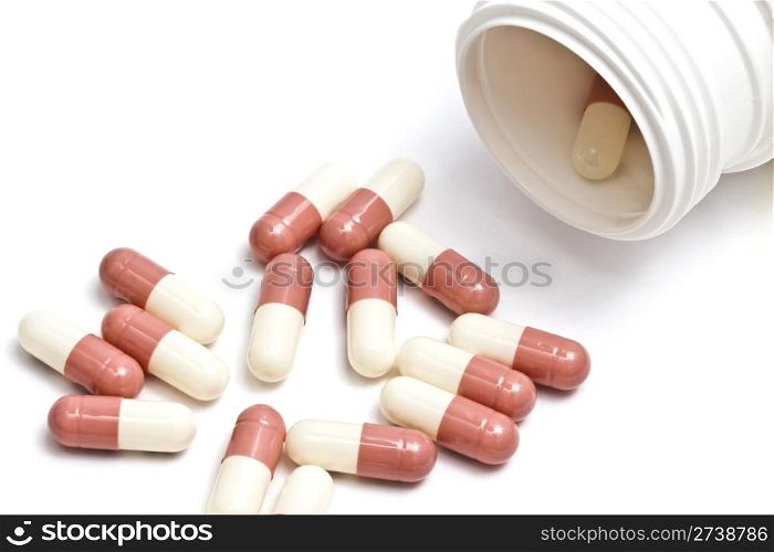 Capsules and bottle isolated on white background