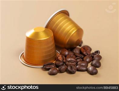 Capsules with coffee drink and raw fresh beans on beige.