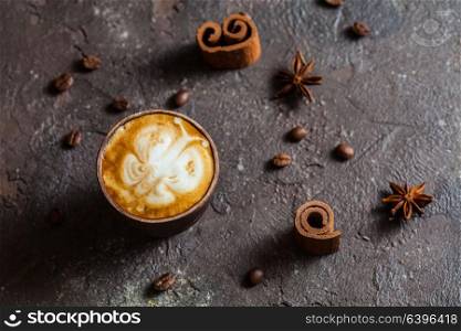 Capuccino still life - butterfly latte art in the handmade clay cup and spices. Butterfly latte art