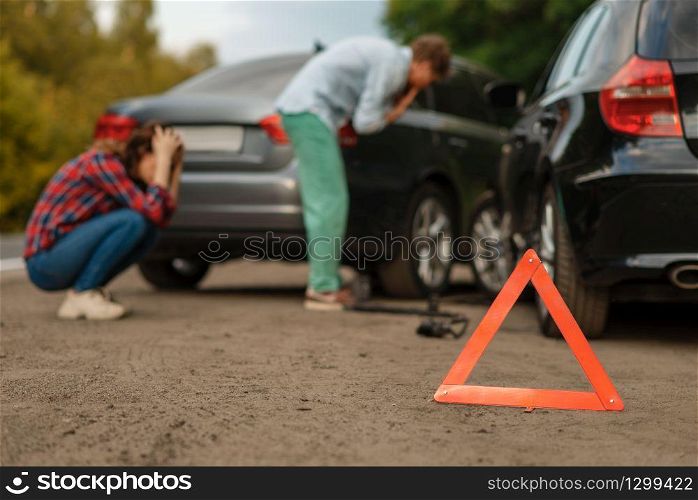 Car accident on road, male and female drivers. Automobile crash, emergency stop sign. Broken automobile or damaged vehicle, auto collision on highway