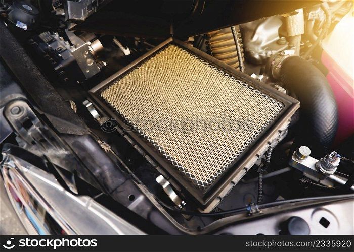 Car air filter on the air filter slot in the car engine system with a sunlight, Automotive parts concept