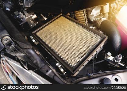 Car air filter on the air filter slot in the car engine system with a sunlight, Automotive parts concept