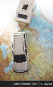 Car and caravan on globe. Miniature concept