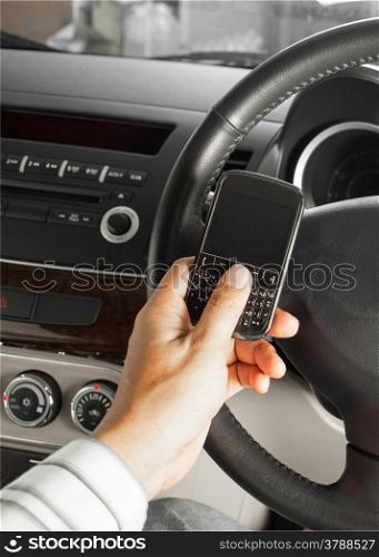 car and road safety concept, businessman text message and driving