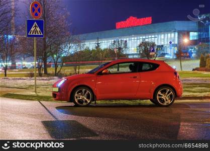 Car at evening near the airport , stoped at pedestrian crossing, Riga, Latvia 