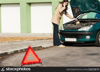 Car breakdown couple calling for road assistance look engine