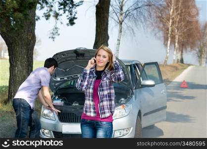 Car breakdown couple calling for road assistance man look engine