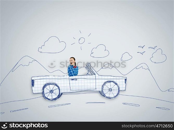 Car concept. Young woman driving car made of paper