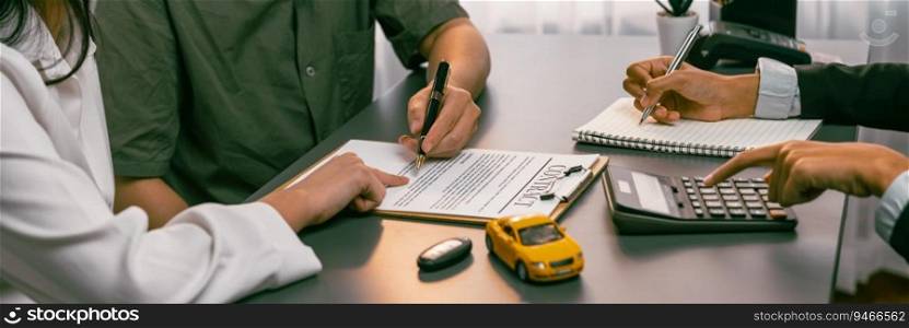 Car dealer calculate interest rate and costs of car loan with calculator, explaining details to customer on term and agreement in dealership office, offering financial and insurance service. Prodigy. Car dealer calculate interest rate and costs of car loan. Prodigy